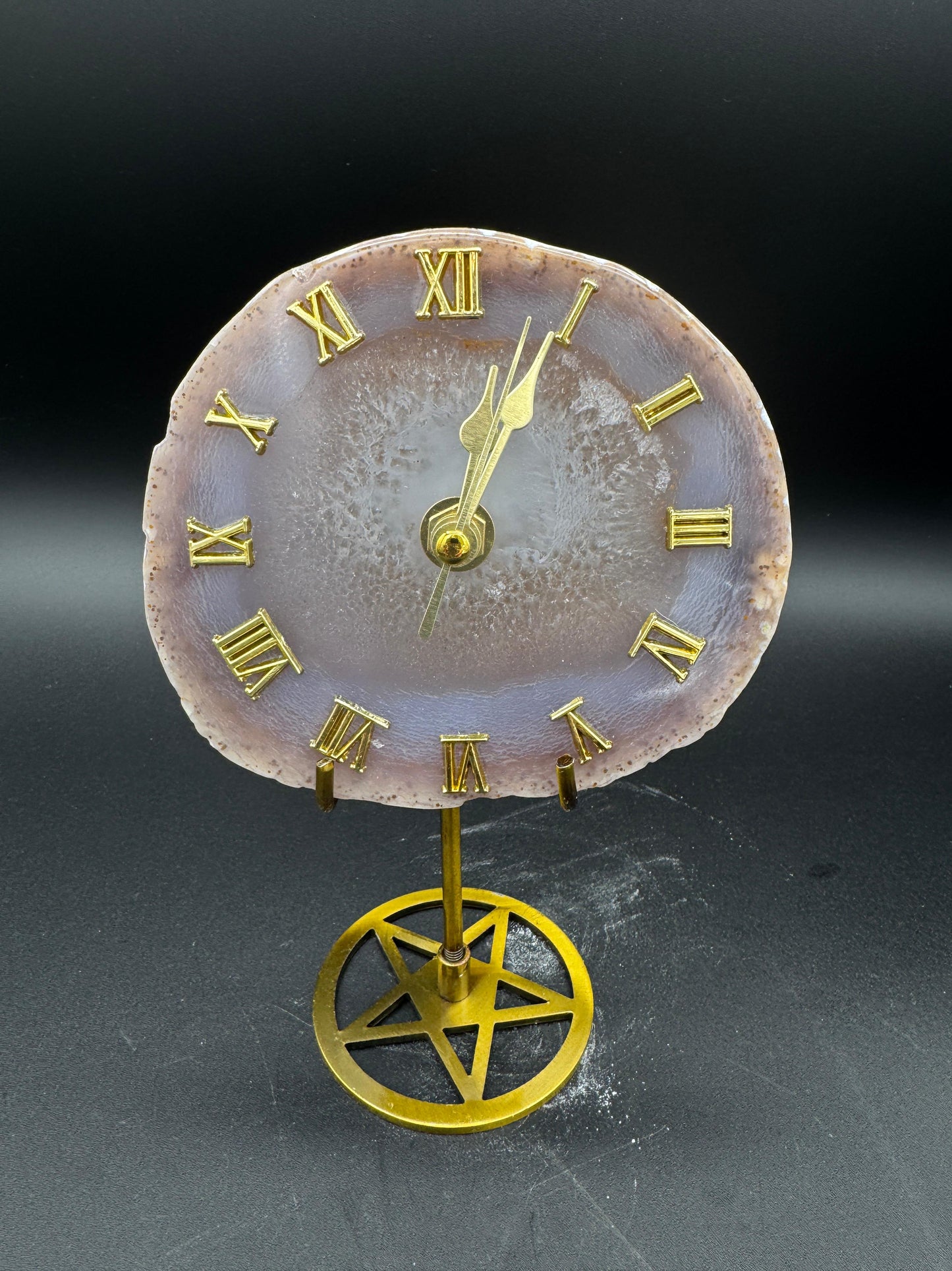 Decorative clock with Roman numerals on a dark background